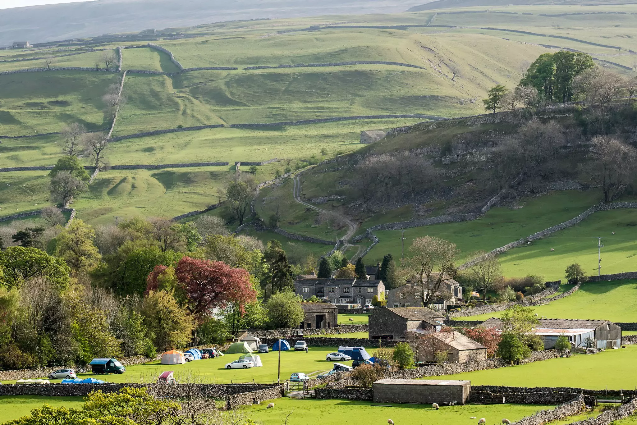 A view over green fields at Kettlewell, Upper Wharfedale, Yorkshire Dales National Park, North Yorkshire, England.