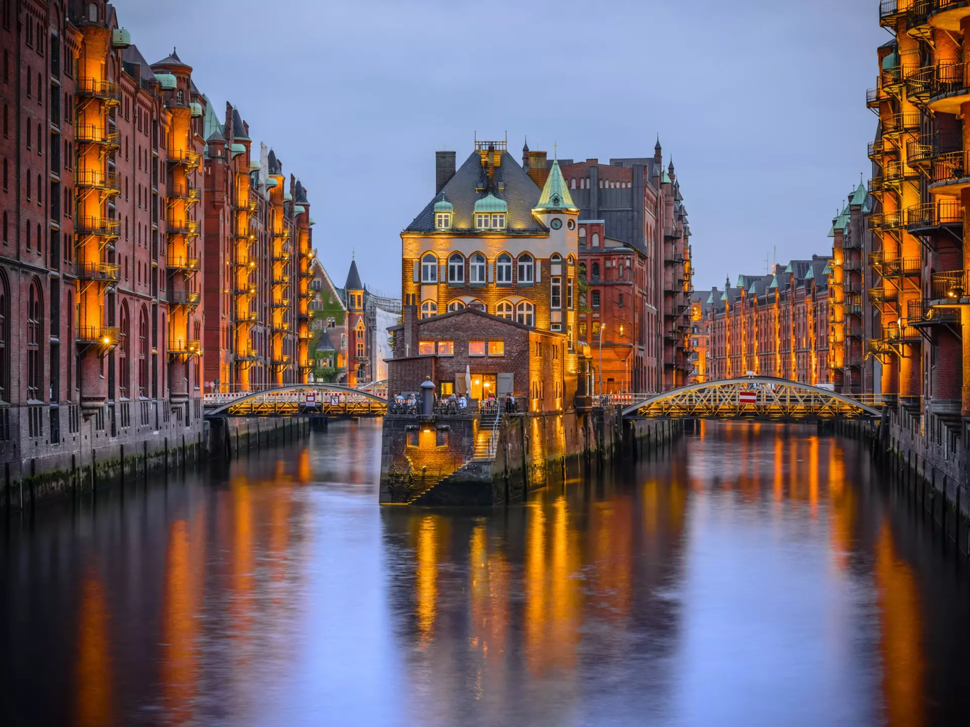Hamburg city of warehouses at night with lights reflecting on the River Elbe