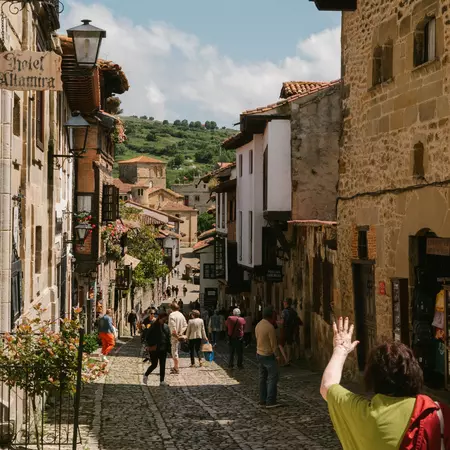 People strolling through medieval streets.