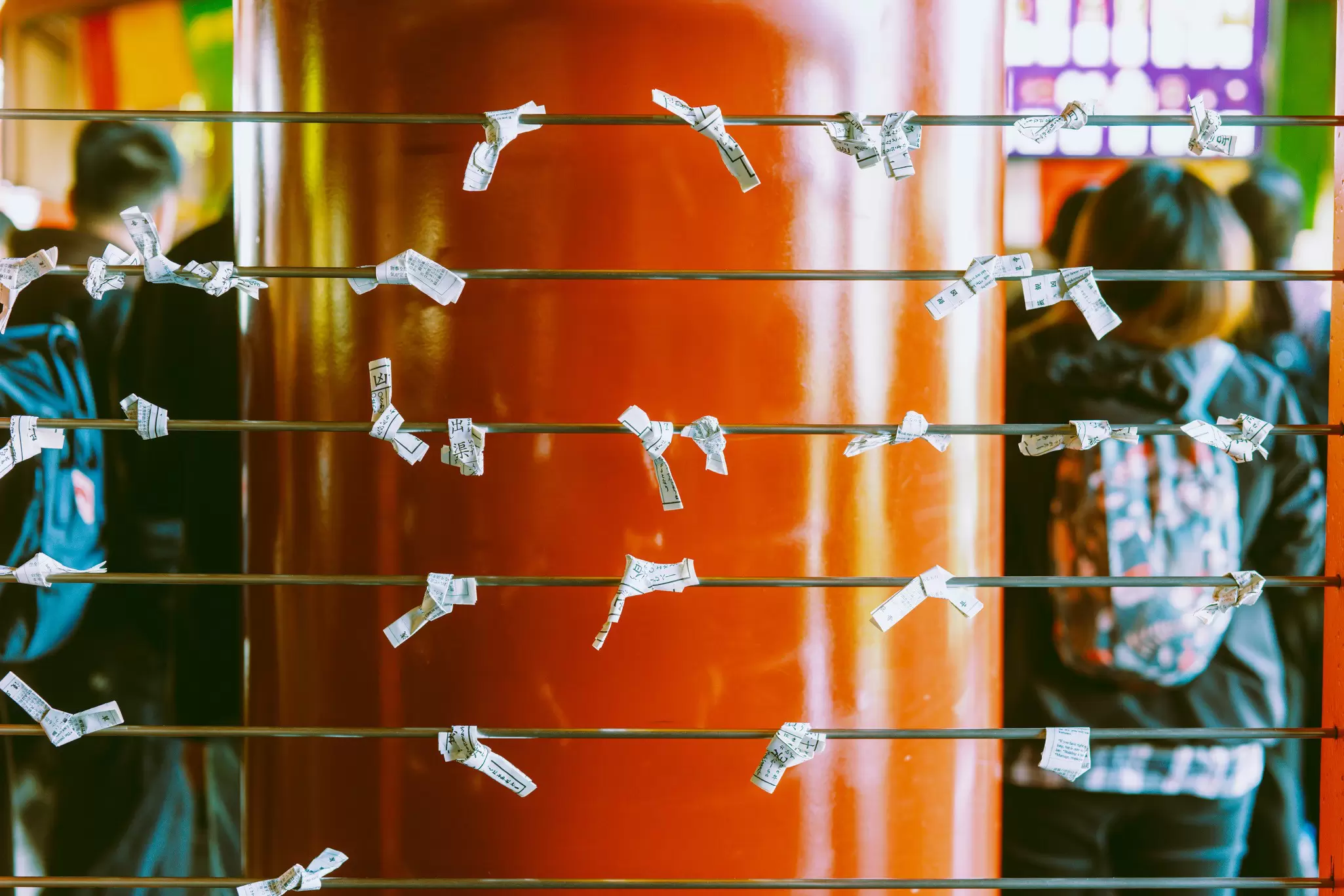 TOKYO, JAPAN. APRIL 2025. 
ASAKUSA
Omikuji (fortunes) tied on metal rods at Sensō-ji