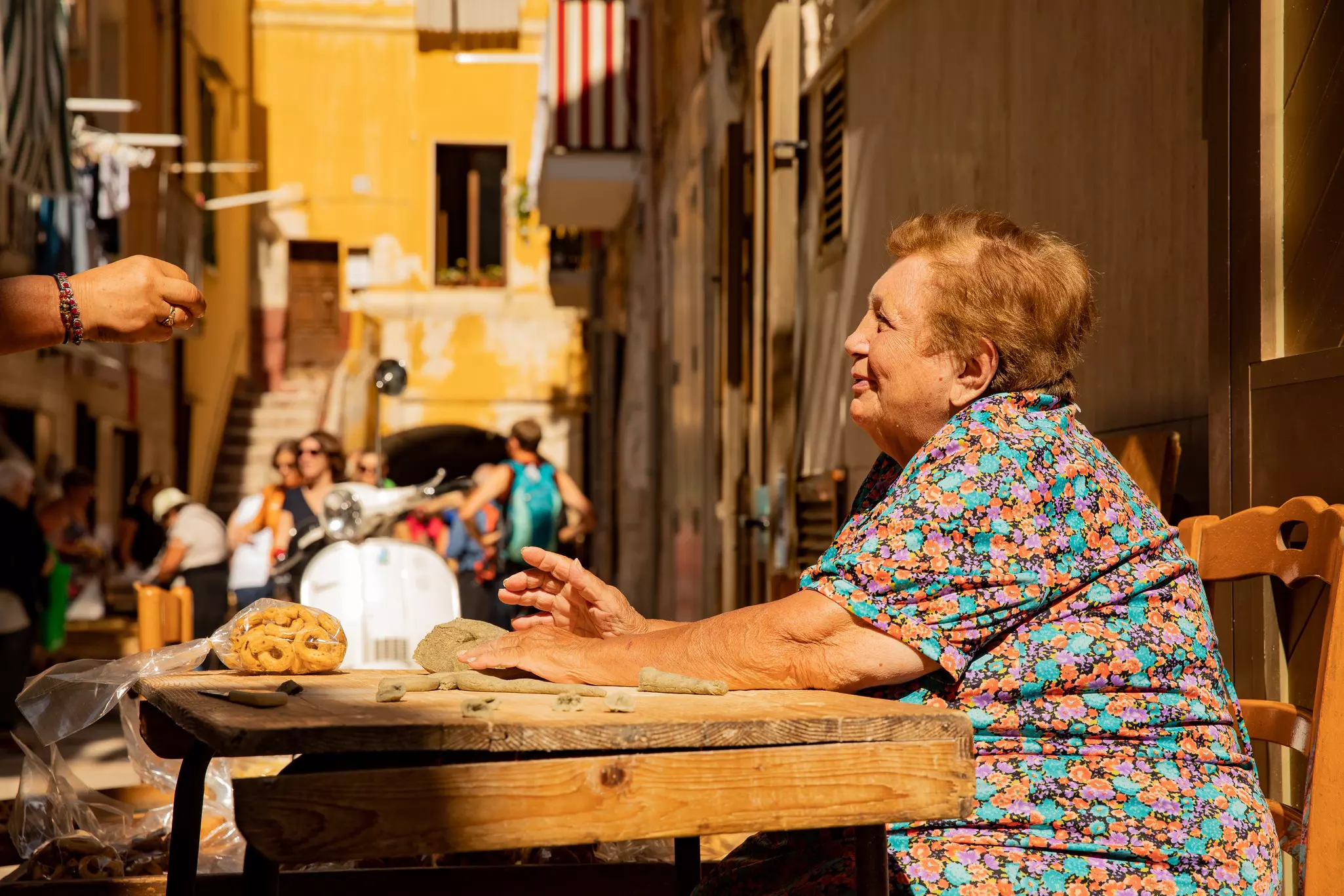 Bari, Puglia / Italy - september - Old woman making fresh pasta (Orecchiette,) in the sun in Viadelle Orecchiette, a famous street in Bari, License Type: media, Download Time: 2025-02-07T16:47:26.000Z, User: rhylton_redventures, Editorial: true, purchase_order: 65030 - Newsletter, job:  Lonely Planet WIP, client: Lonely Planet WIP, other: Rhianydd Hylton