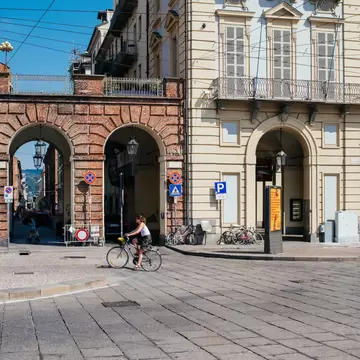 A cyclists rides through an empty square in Turin, Italy. 