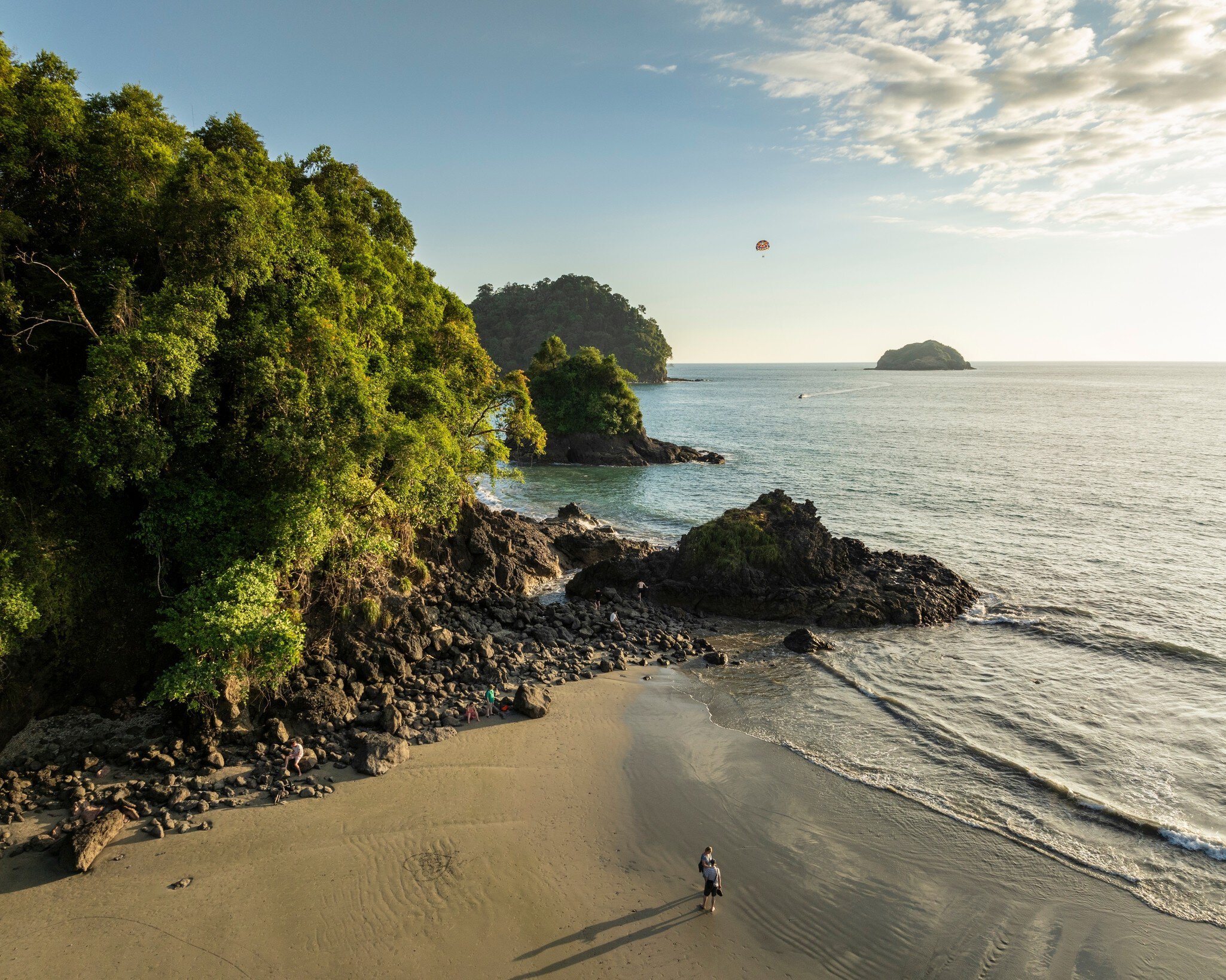 Aerial view of a couple looking out over the water during sunset on Manuel Antonio Beach, Manuel Antonio National Park.