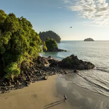 Aerial view of a couple looking out over the water during sunset on Manuel Antonio Beach, Manuel Antonio National Park.