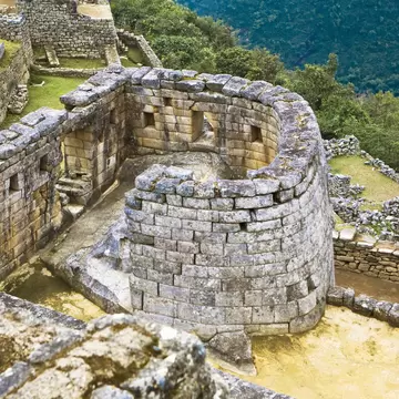 High angle view of the ruins of the circular Temple of The Sun in Machu Picchu, Urubamba Valley, Cuzco, Peru.