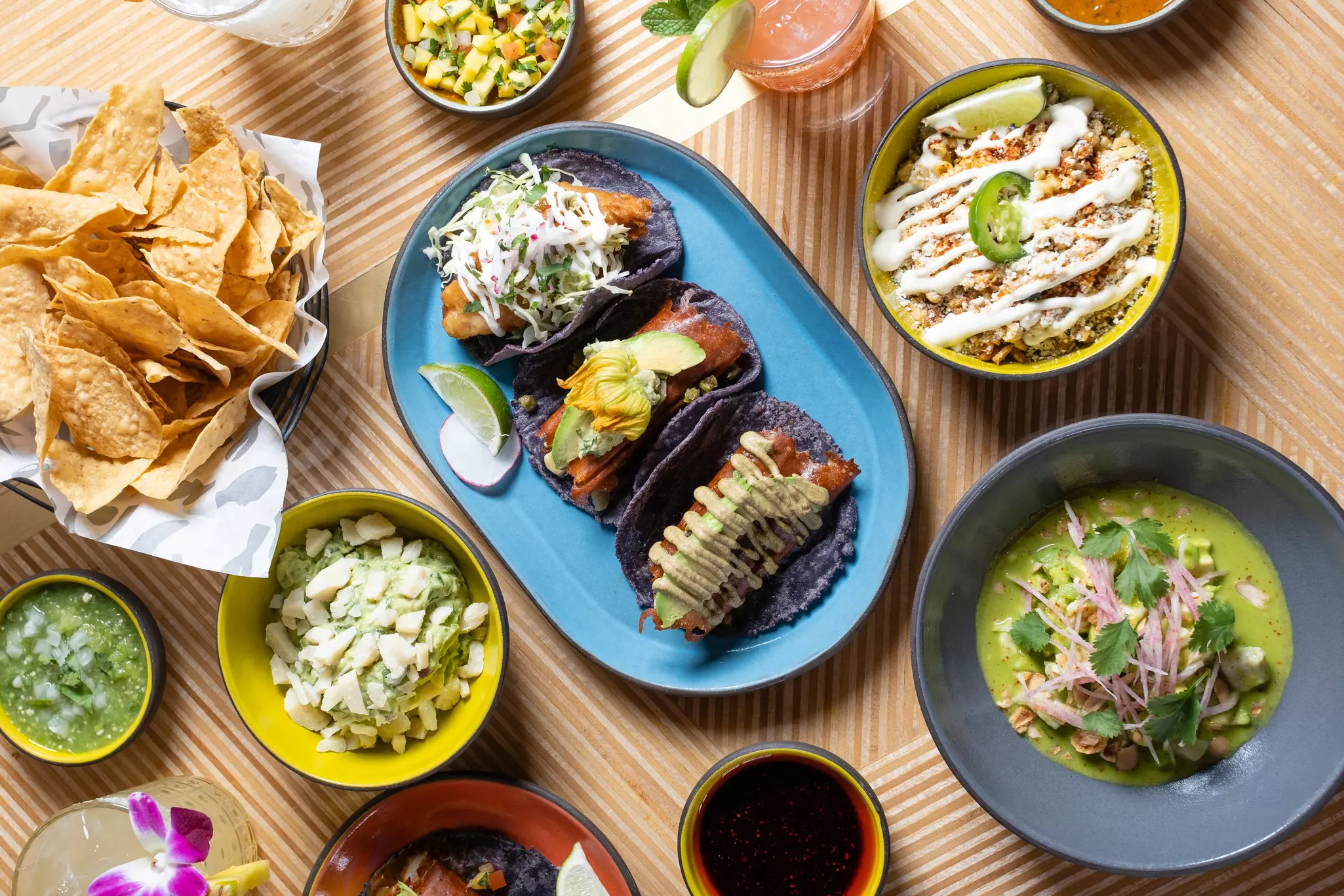 Mexican-style dishes on small plates including loaded tacos, tortillas, salads and sauces.