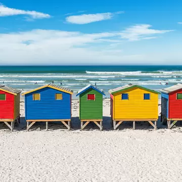 The famous beach of Muizenberg (also known as surfers paradise), with its colorful beach boxes.