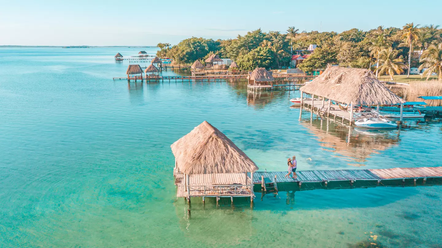 Aerial view of a Couple in Bacalar pier, Riviera Maya, Mexico