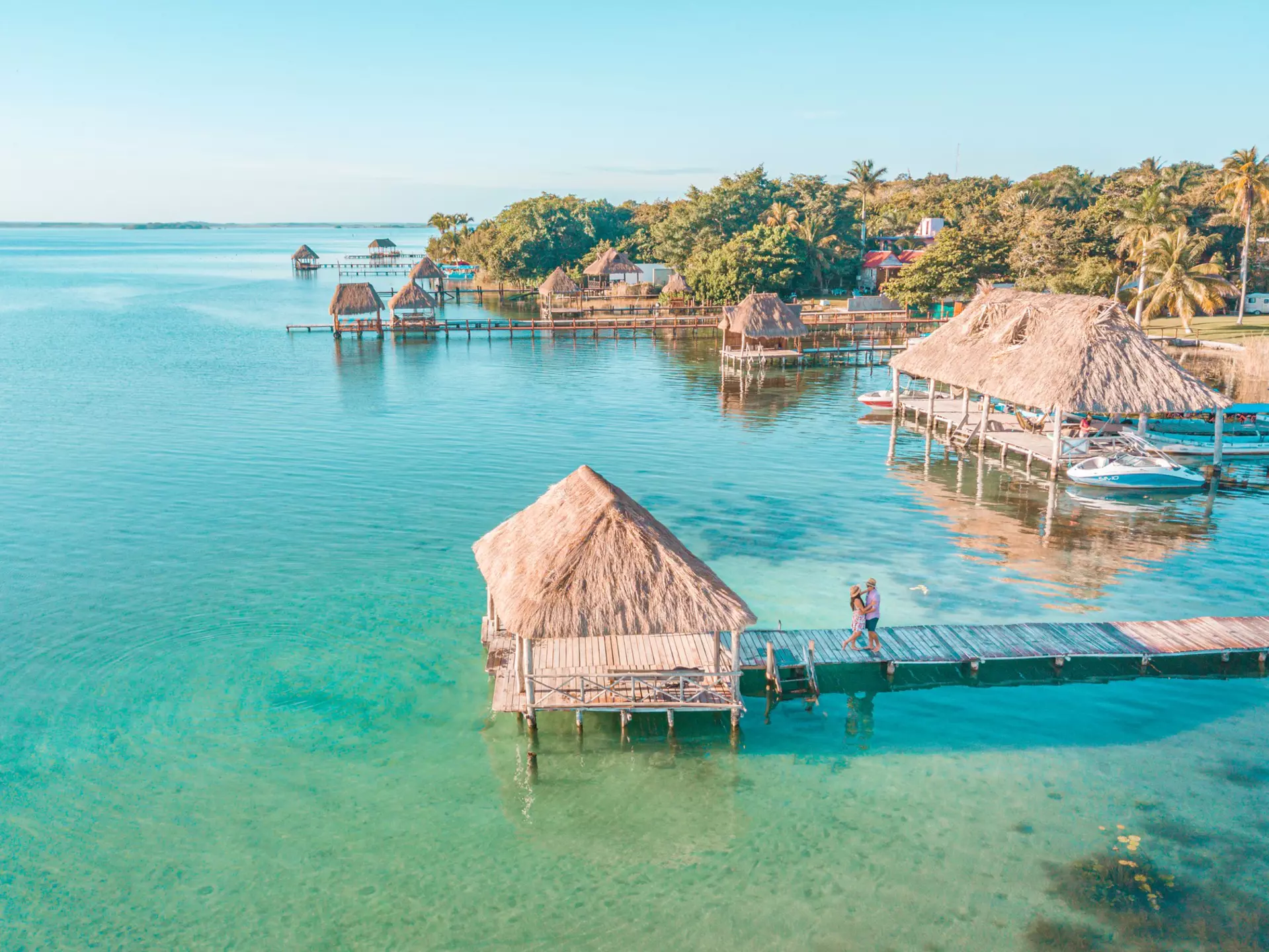 Aerial view of a Couple in Bacalar pier, Riviera Maya, Mexico