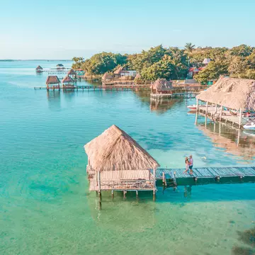 Aerial view of a Couple in Bacalar pier, Riviera Maya, Mexico