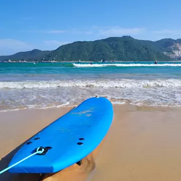 View of a surfboard on the beach by Houhai Fishing Village in Sanya, China.