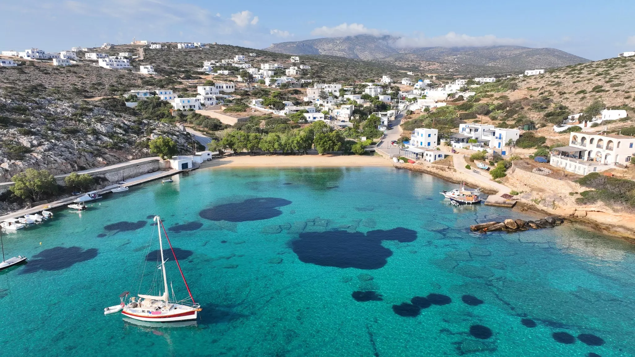 Aerial photo of a beach on an island with clusters of white buildings