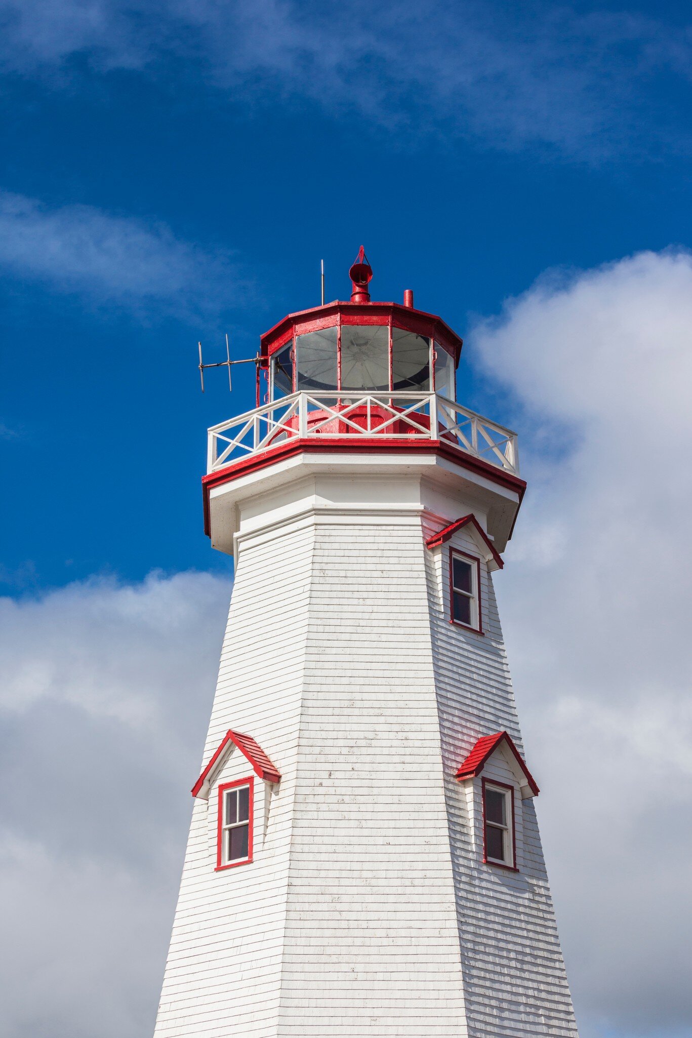 View of the East Point Lighthouse against a blue sky on Prince Edward Island, Canada.