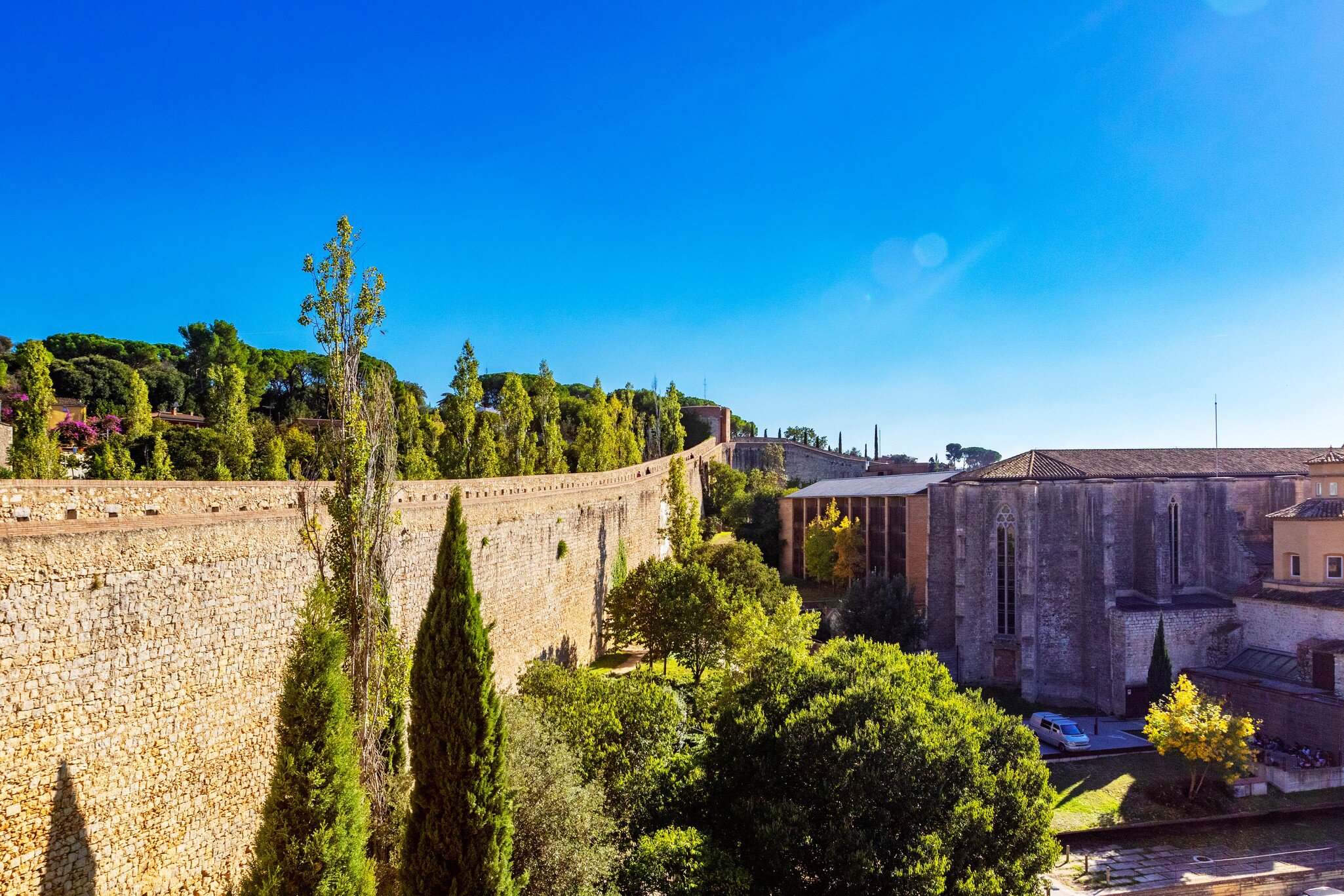 View of the Muralles de Girona, the old city walls in Girona, Spain, on a sunny day.