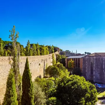 View of the Muralles de Girona, the old city walls in Girona, Spain, on a sunny day.
