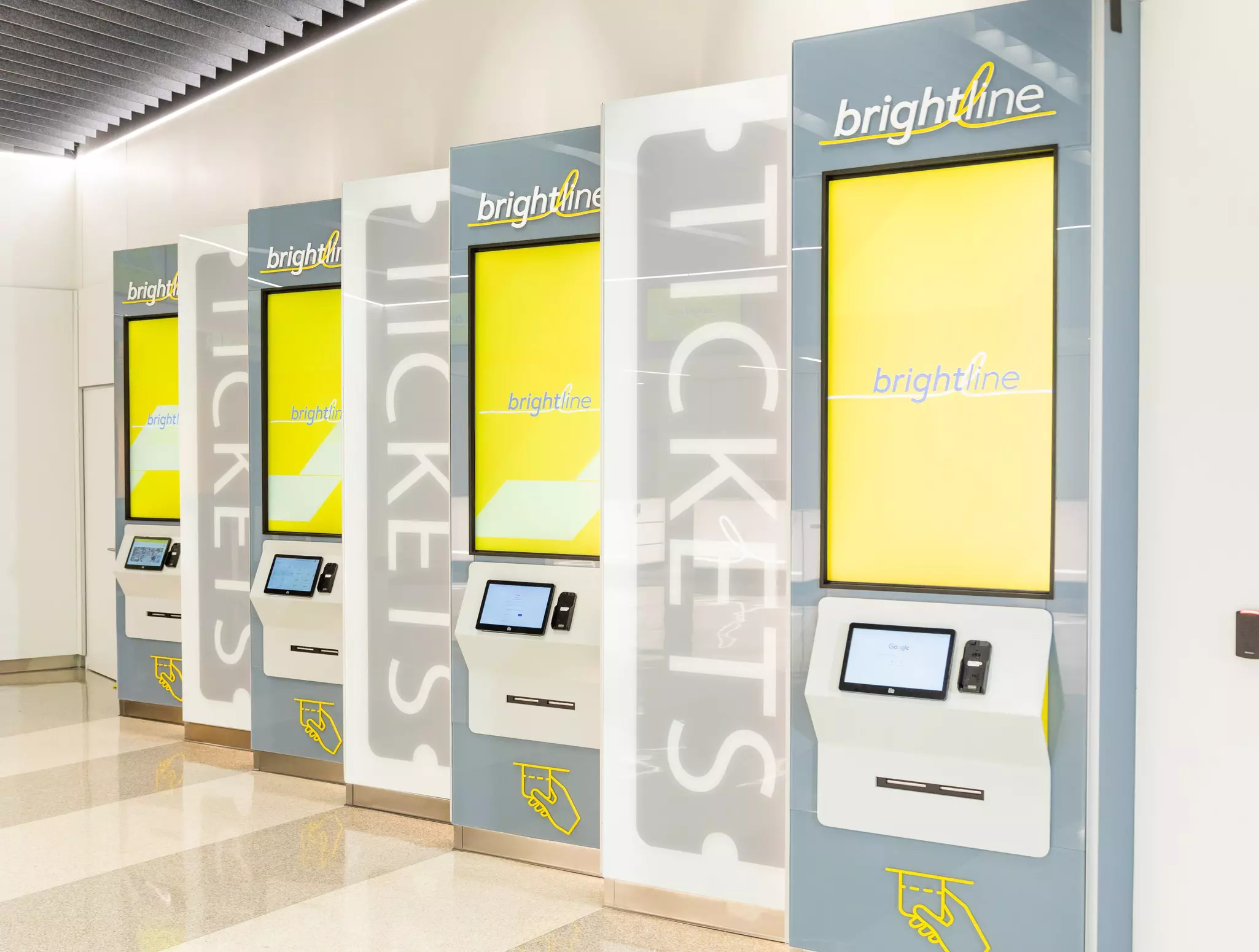 Brightly colored ticket kiosks in Orlando International Airport. © Brightline Orlando