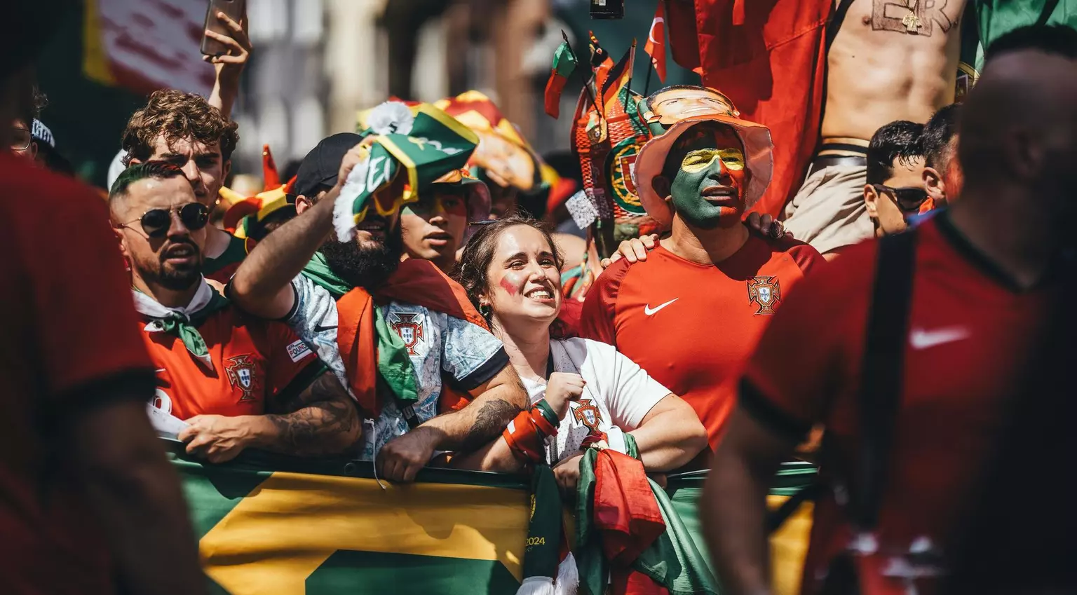 Passionate Portugal football supporters cheering with flags and scarves in vibrant celebration.
Downloaded for World Cup usage