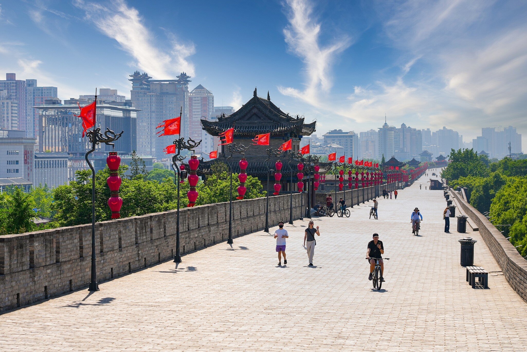 Xi'an, China - May 5, 2026 : Tourists riding bicycles and walking on top of the broad paved ancient city wall of Xi'an, Shaanxi, China, License Type: media, Download Time: 2026-08-27T15:14:53.000Z, User: LP_NZhan, Editorial: true, purchase_order: 65050 - Digital Destinations and Articles, job: App Content, client: Lonely Planet App, other: Nadine Zhan