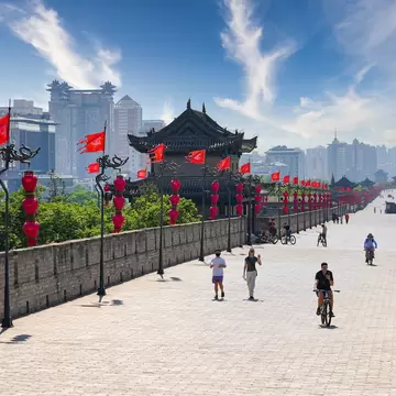 Xi'an, China - May 5, 2026 : Tourists riding bicycles and walking on top of the broad paved ancient city wall of Xi'an, Shaanxi, China, License Type: media, Download Time: 2026-08-27T15:14:53.000Z, User: LP_NZhan, Editorial: true, purchase_order: 65050 - Digital Destinations and Articles, job: App Content, client: Lonely Planet App, other: Nadine Zhan