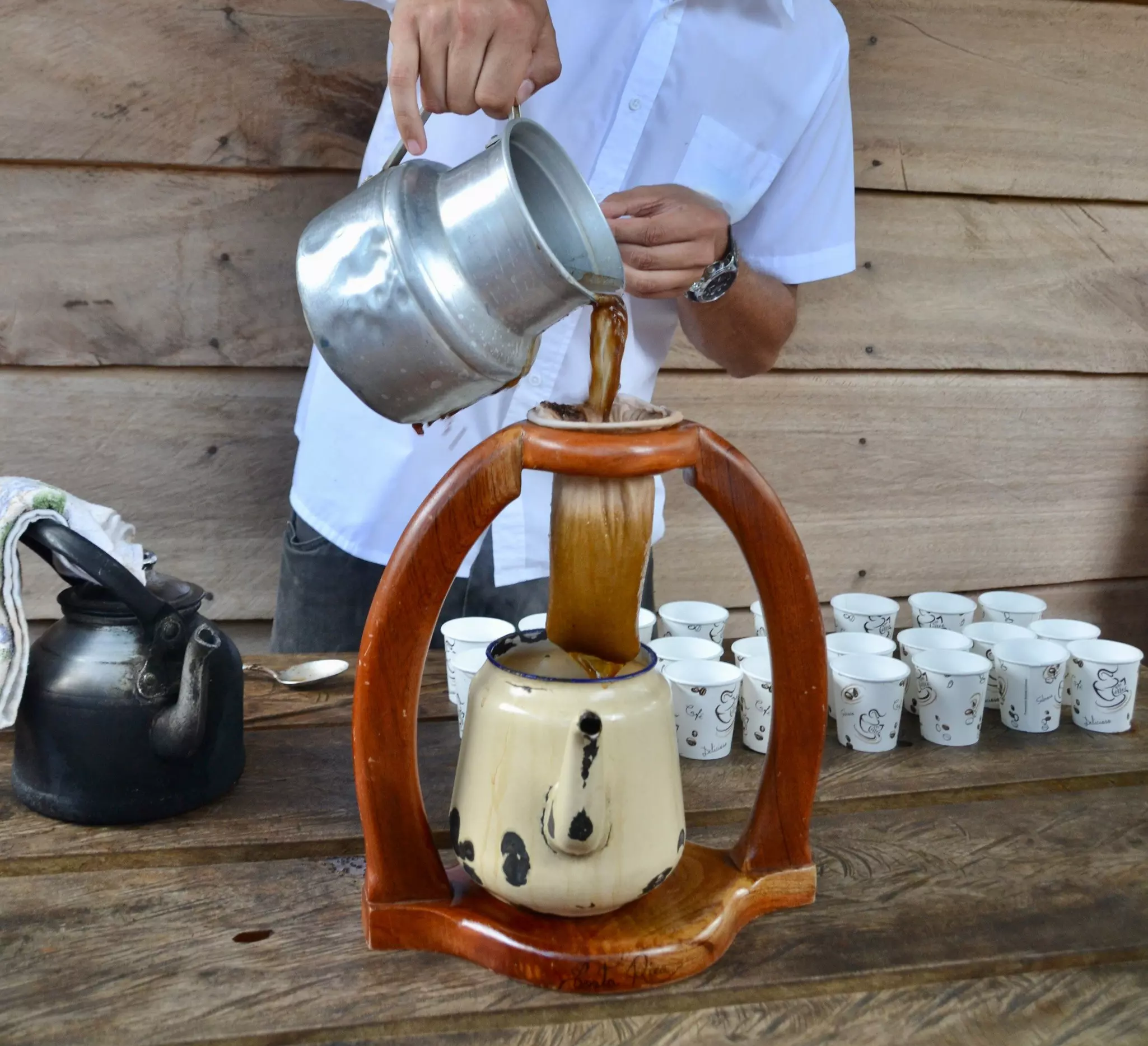 Coffee is poured through a strainer as part of a demonstration of traditional coffee brewing in Costa Rica. 