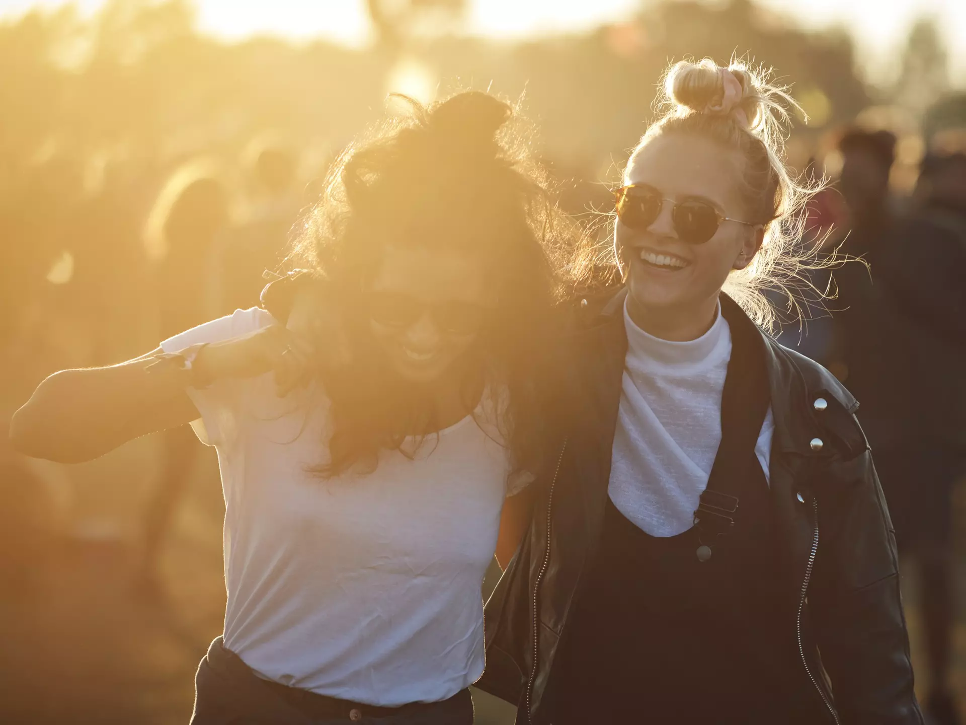 Friends laughing together at big festival in Denmark