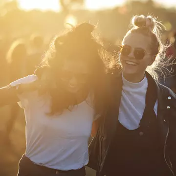 Friends laughing together at big festival in Denmark