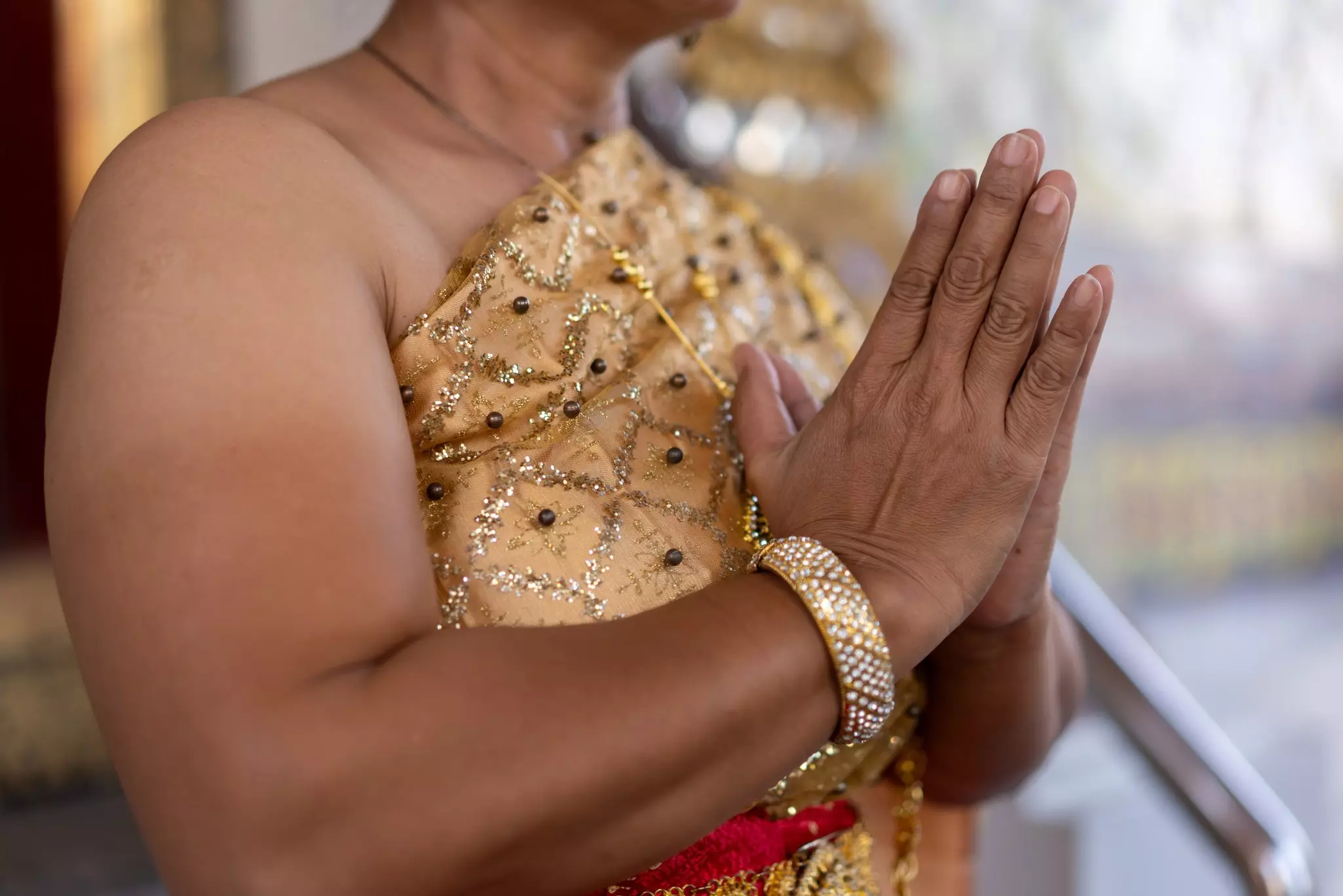 A woman performs the traditional Thai greeting. 