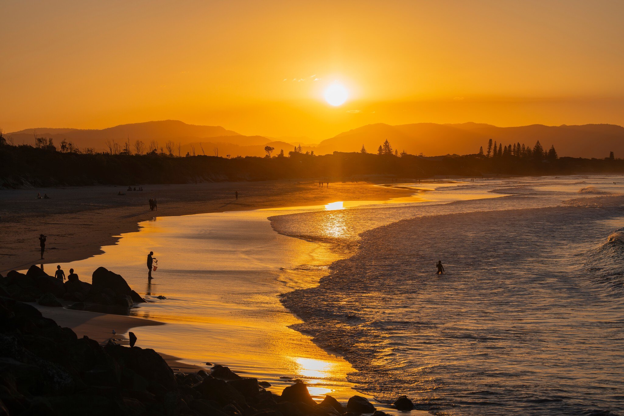 Byron Bay, July 22, 2023. Sunset view of surfers in silhouette along the Belongil Beach area in Byron Bay, New South Wales, Australia  License Type: media  Download Time: 2024-04-17T01:23:35.000Z  User: claramonitto  Is Editorial: Yes  purchase_order:   