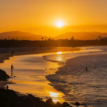 Byron Bay, July 22, 2023. Sunset view of surfers in silhouette along the Belongil Beach area in Byron Bay, New South Wales, Australia  License Type: media  Download Time: 2024-04-17T01:23:35.000Z  User: claramonitto  Is Editorial: Yes  purchase_order:   