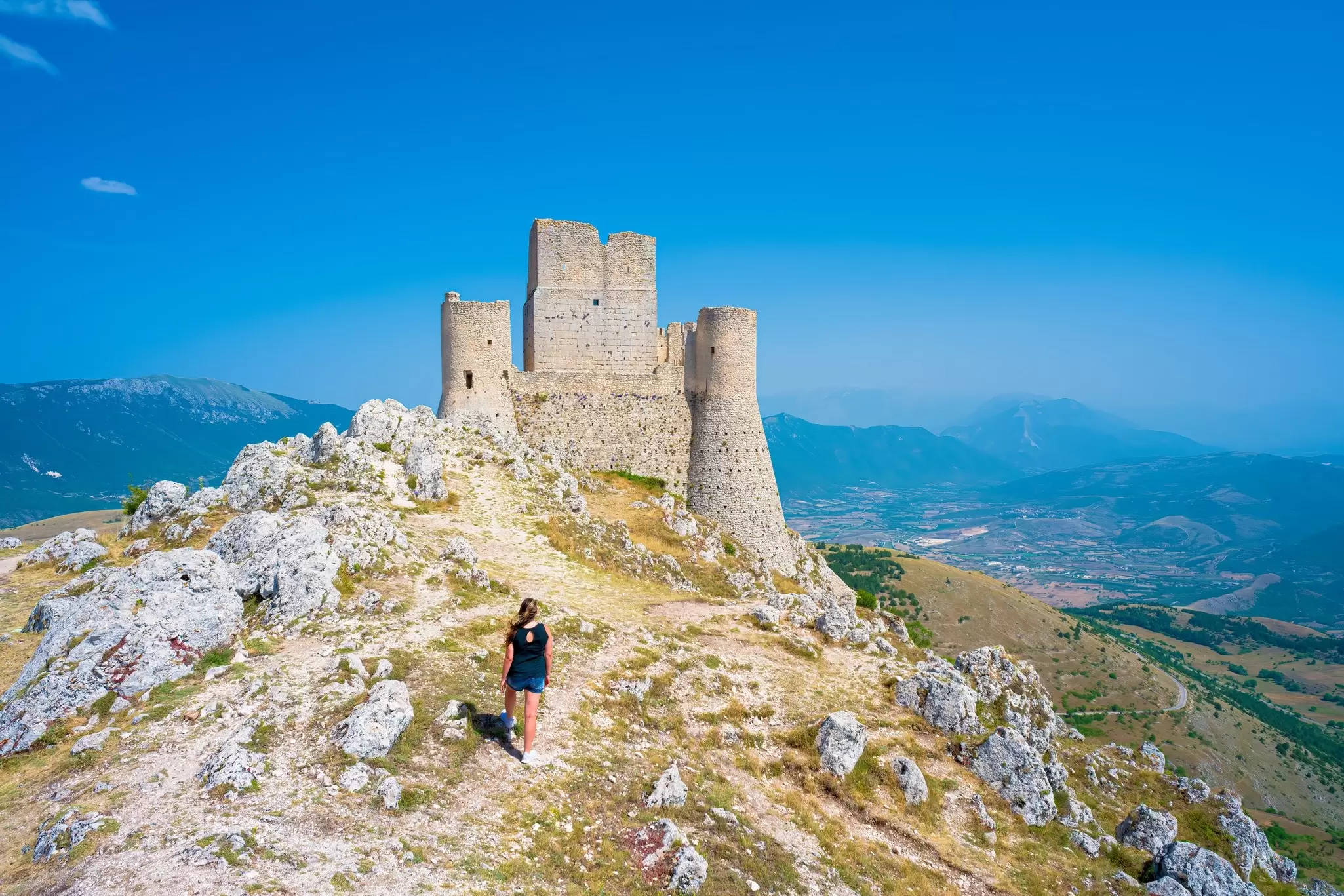 A hiker approaches the ruins of the castle of Rocca Calascio in Abruzzo, Italy. 