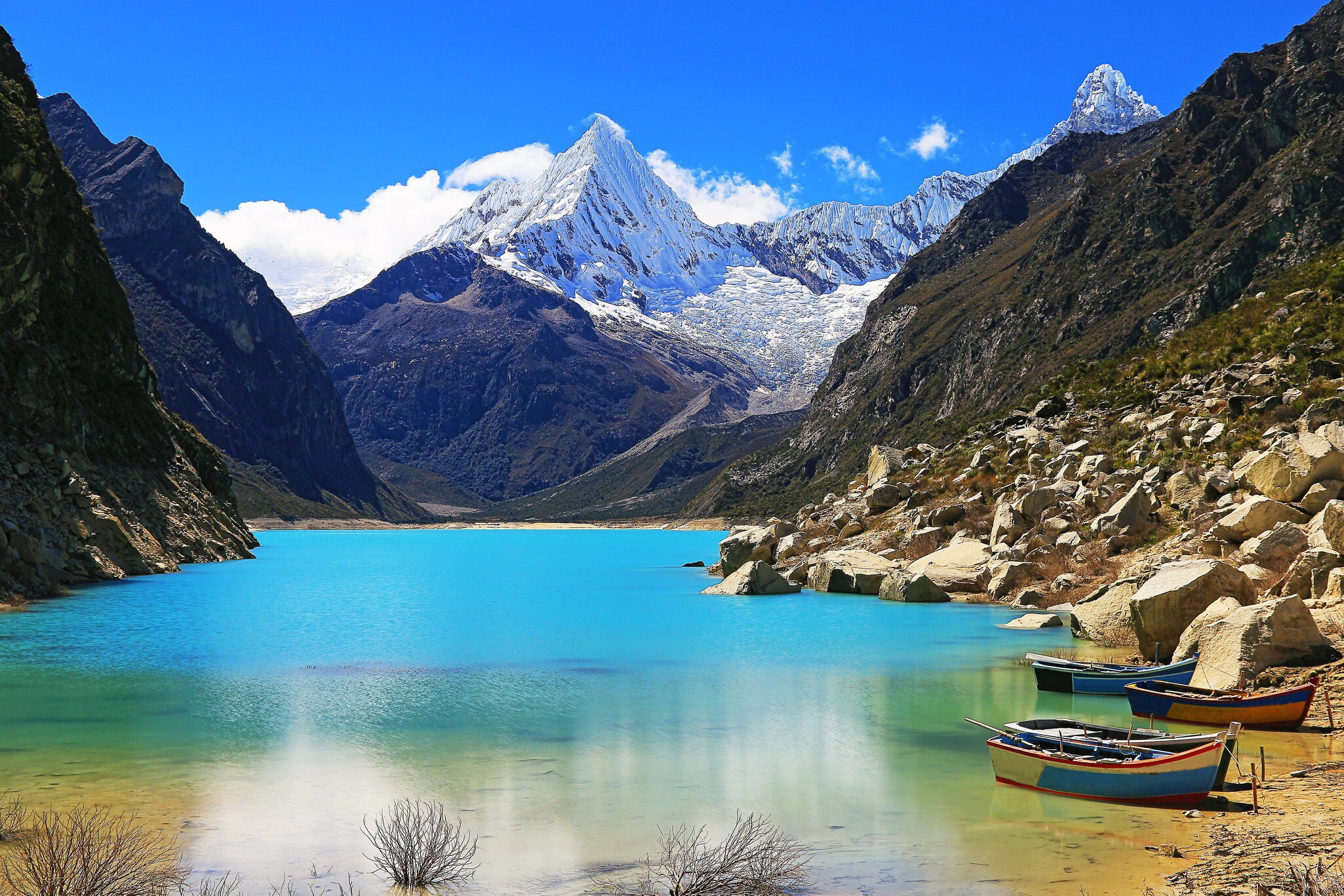 Wooden boats anchored on Lake Parón in the Cordillera Blanca, Peru