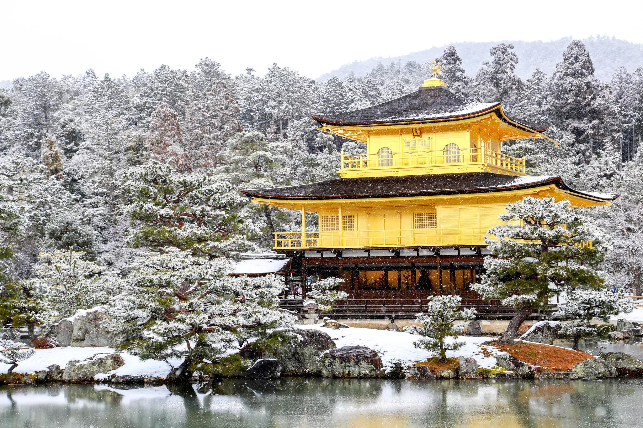 The Golden Pavilion surrounded by snow during winter in Kyoto.