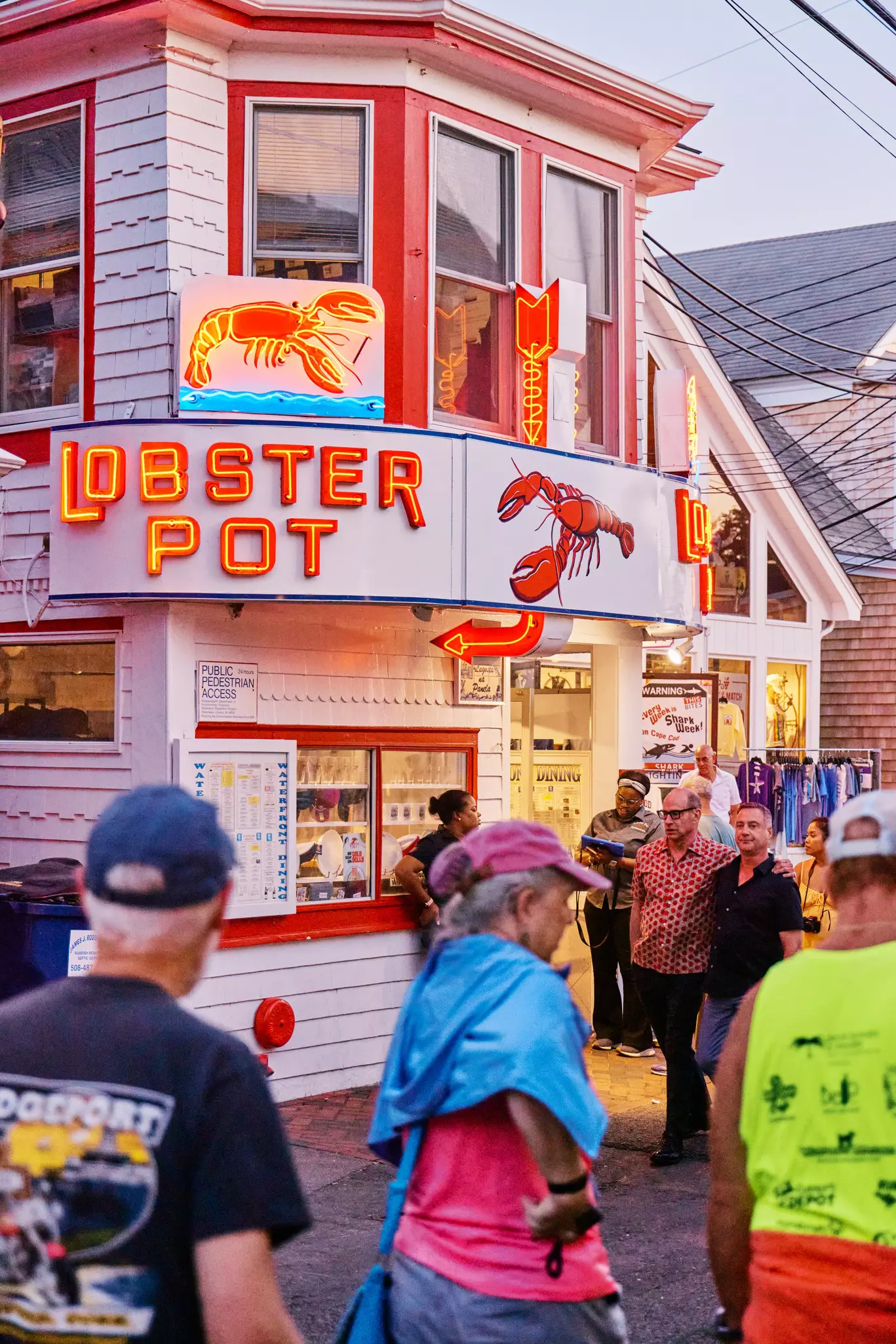 Tourists walk by Lobster Pot restaurant in Provincetown, Massachussetts.
