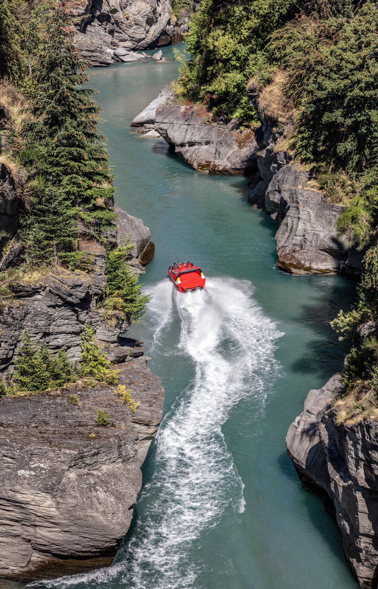 Tourists enjoying a high-speed boat ride on Shotover River near Queenstown, New Zealand.