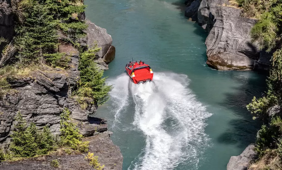 Tourists enjoying a high-speed boat ride on Shotover River near Queenstown, New Zealand.