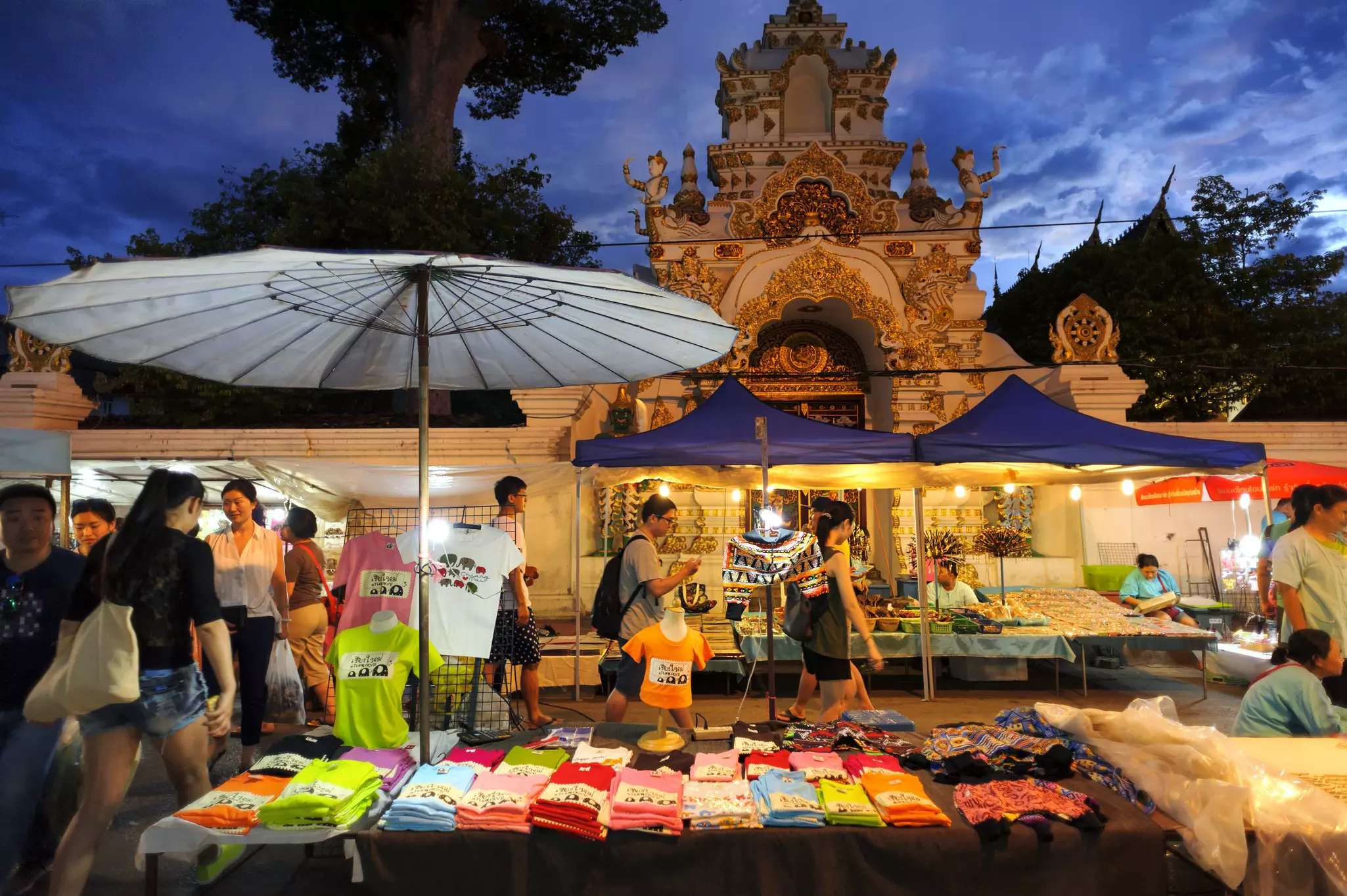 Shoppers passing stalls at the Sunday walking market in Chiang Mai, Thailand. 