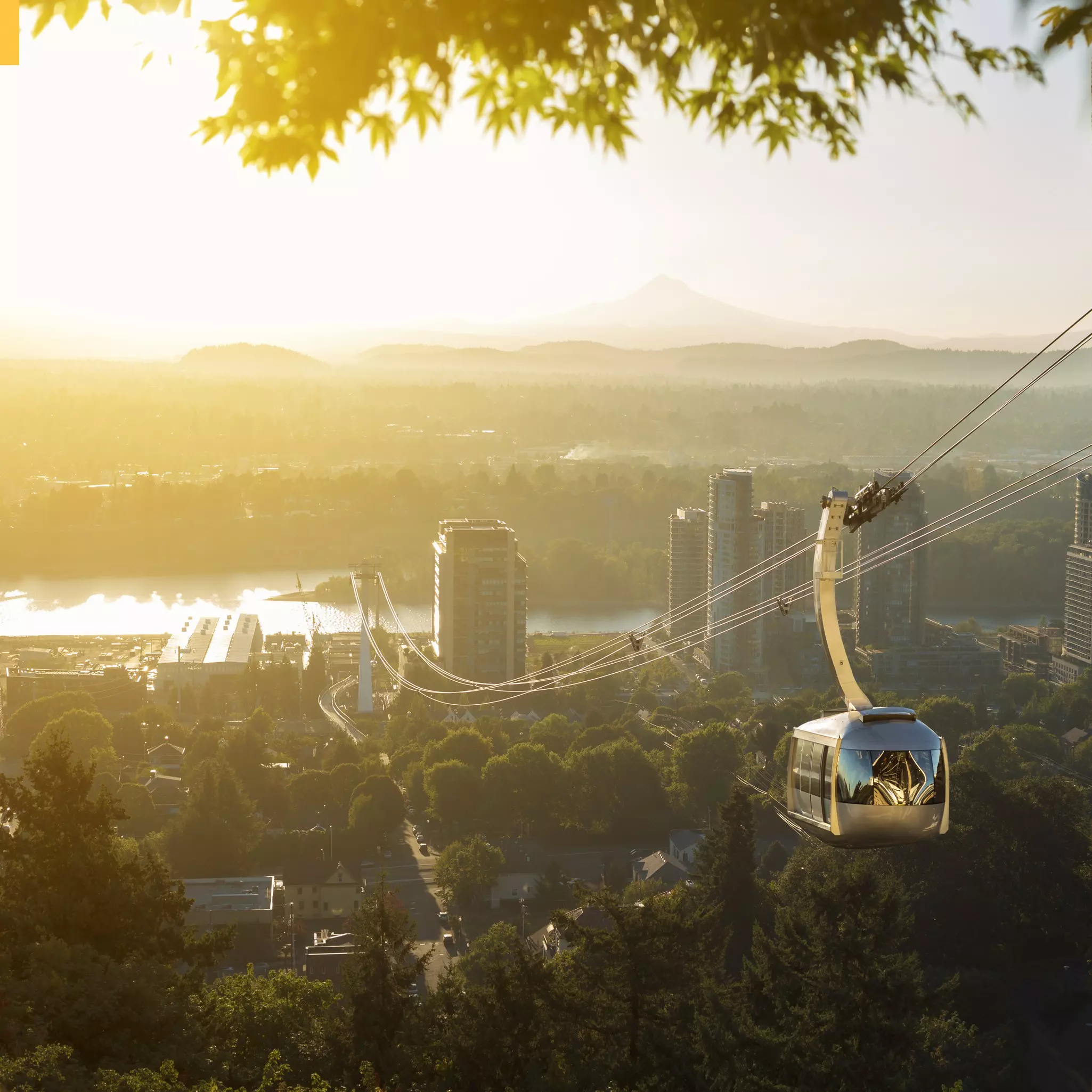 Aerial tram in Portland, Oregon, transporting people to and from the hilltop to Oregon Health and Science University (OHSU) and a view of Mt Hood.