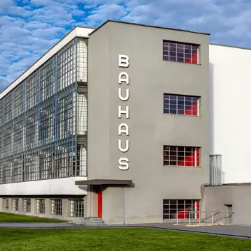 Grey, white and red-colored building with 'Bauhaus' written on the side 