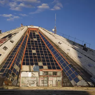 Adults and children climbing up the side of the Pyramid building that housed the former Enver Hoxha Museum, Tirana, Albania, Eastern Europe