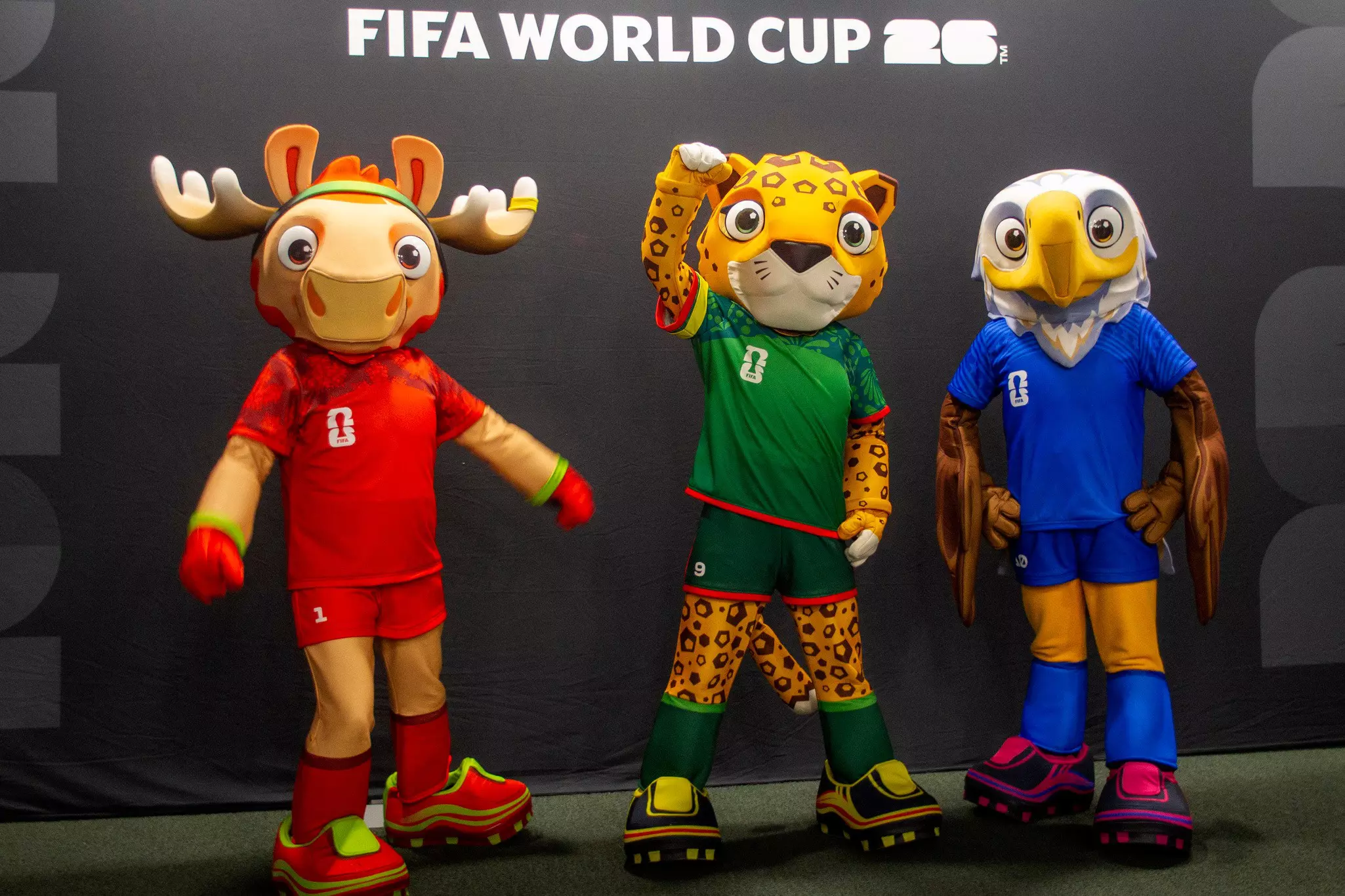 Sports mascots of moose, a jaguar and a bald eagle all wear soccer cleats.