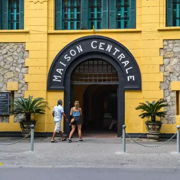 Two people enter the Hoa Lo Prison in Hanoi, Vietnam.