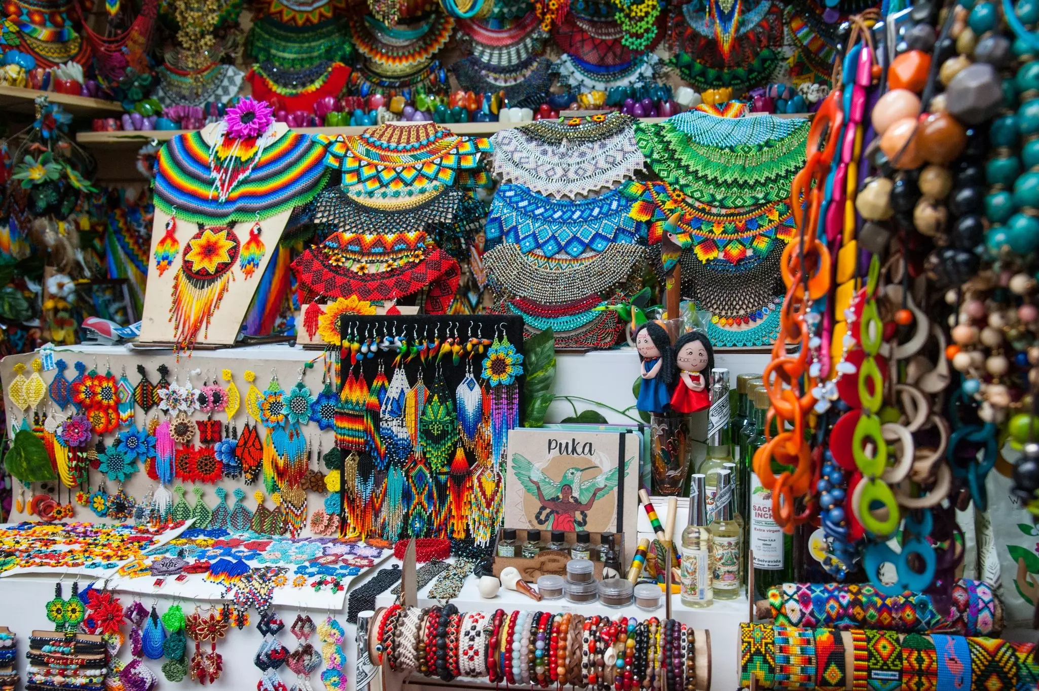 Blankets, hats and other artisanal products for sale at a market stall.