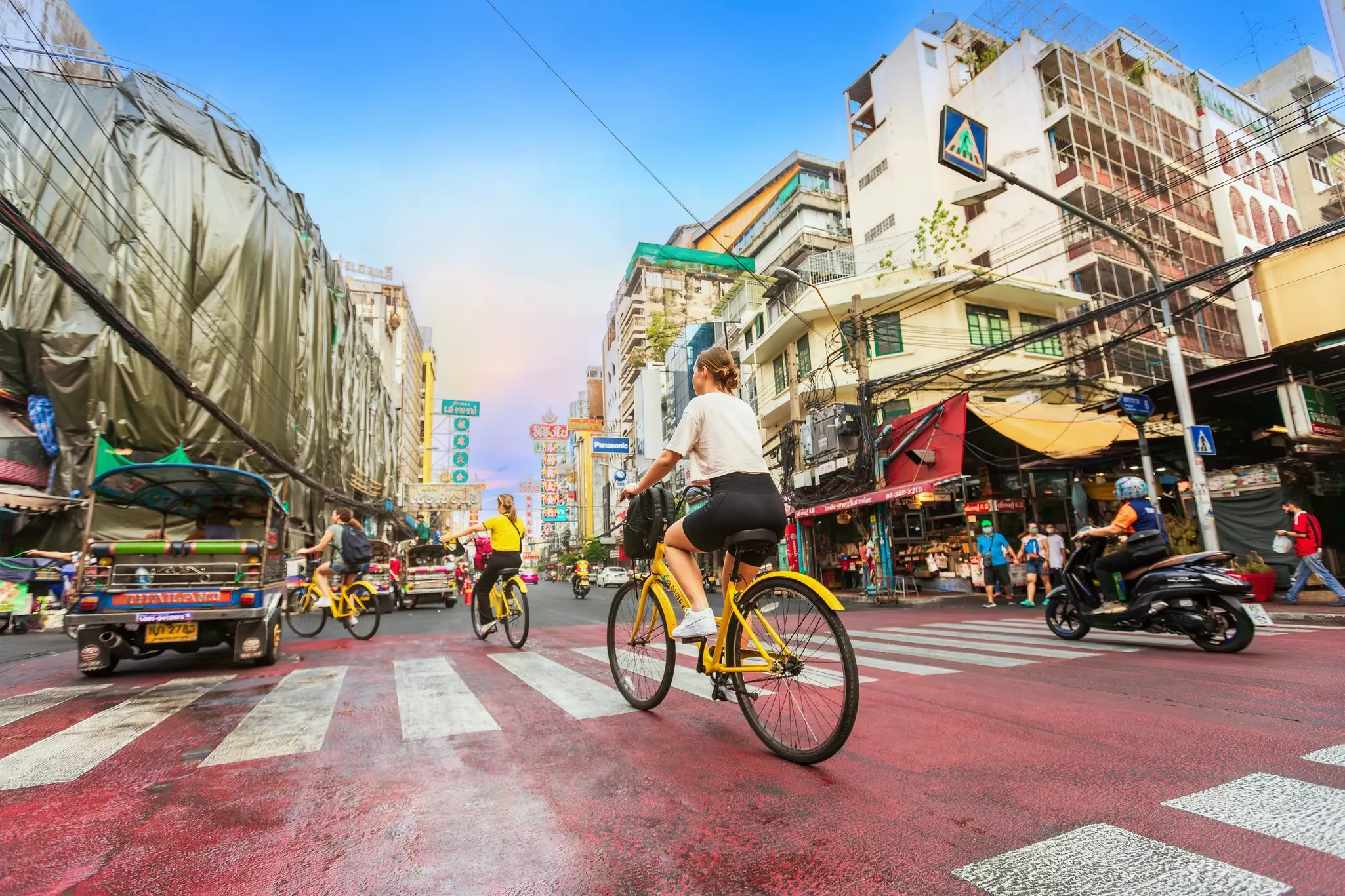 People on yellow bicycles on a city street