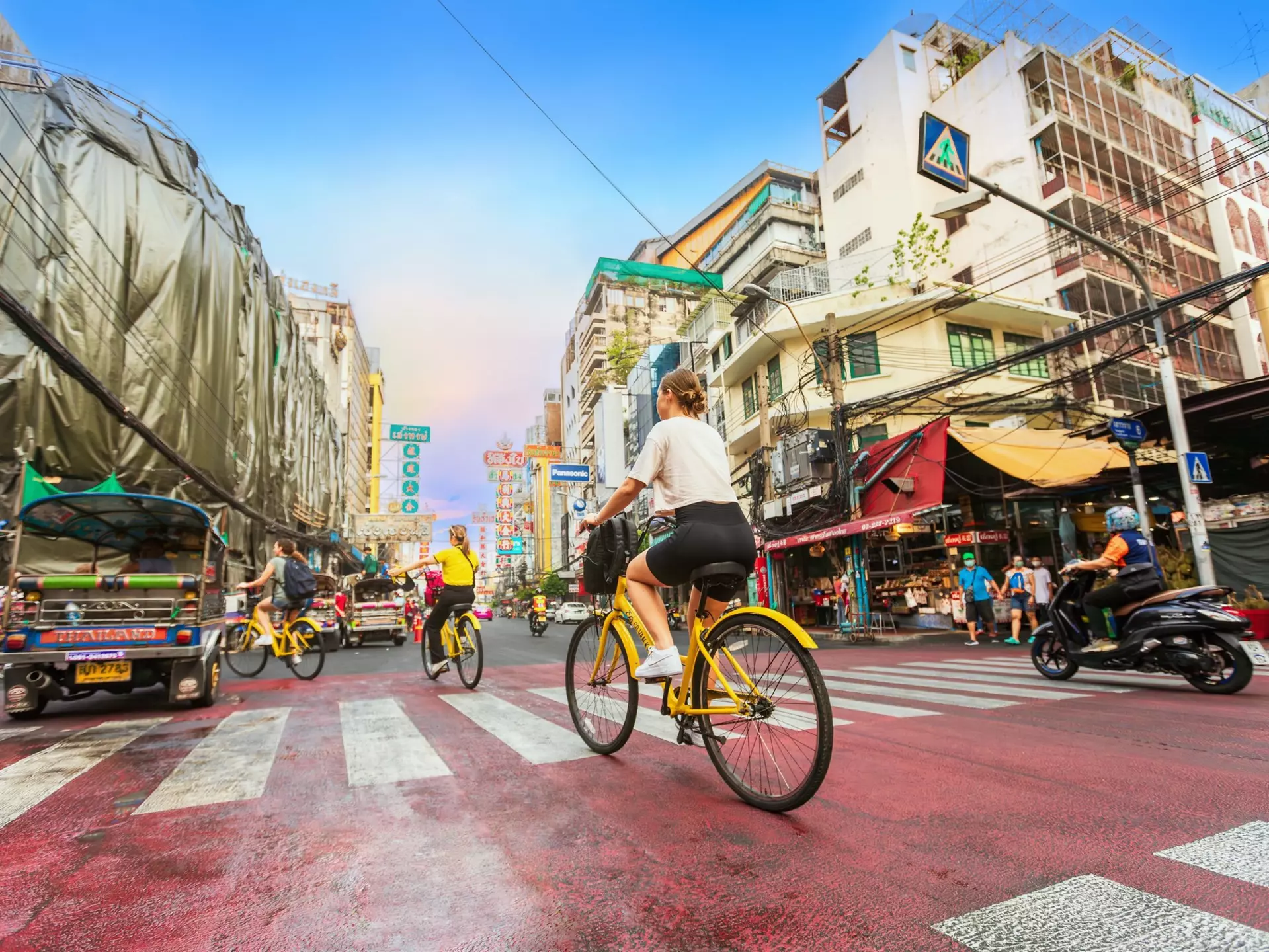 A traveler riding on a bicycle to see the city life in the morning in the Chinatown of Bangkok or Yaowarat Road