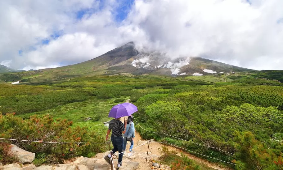 Hikers on the trail around the ropeway's upper station at Asahi-dake Mountain (Mt. Asahidake).