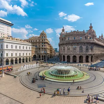 A view over the broad Piazza de Ferrari in Genoa, surrounded by historic buildings, Liguria, Italy.