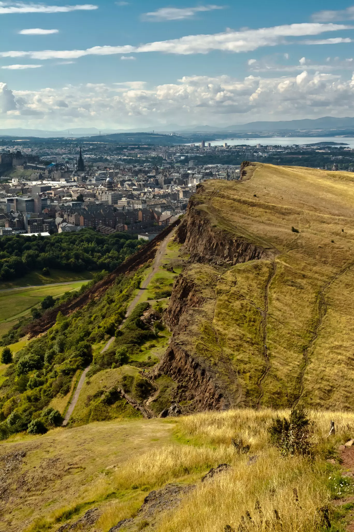 The majestic hill overlooking Edinburgh city on a cloudy day.