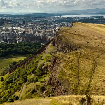 The majestic hill overlooking the city of Edinburgh on a sunny day.