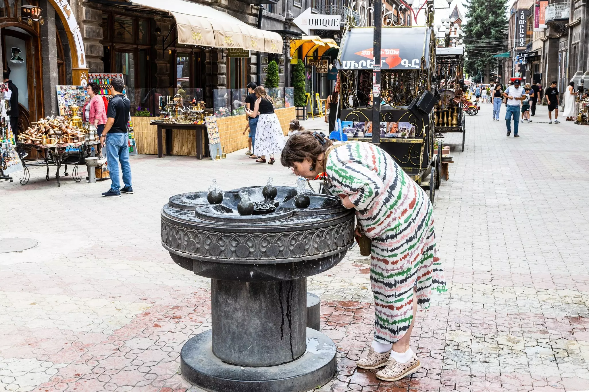Gyumri, Armenia - July 19, 2024: drinking water fountain on Abovyan pedestrian Street in old town of Gyumri city on cloudy summer day