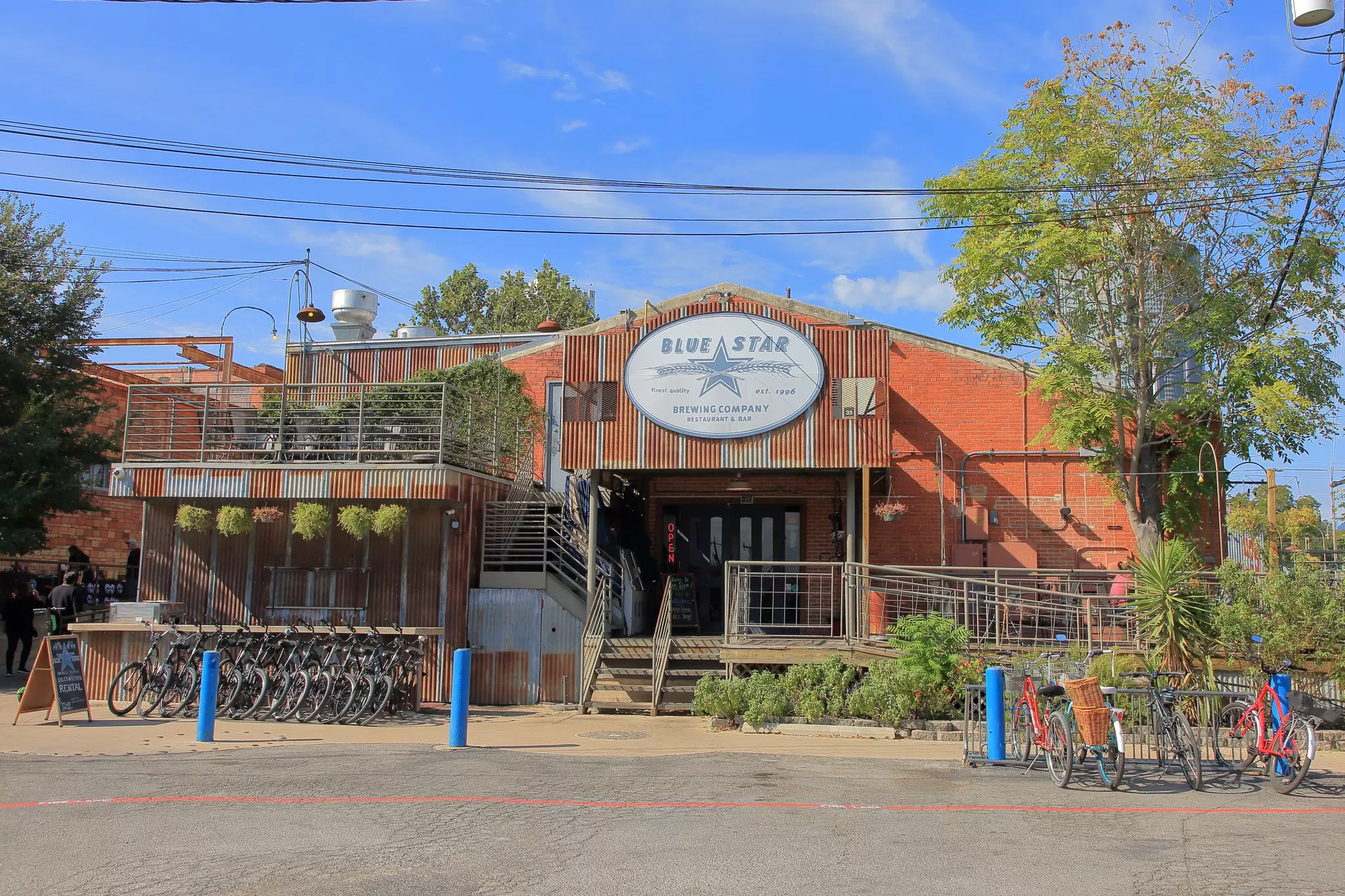 A large warehouse-style building with lots of bikes on racks outside